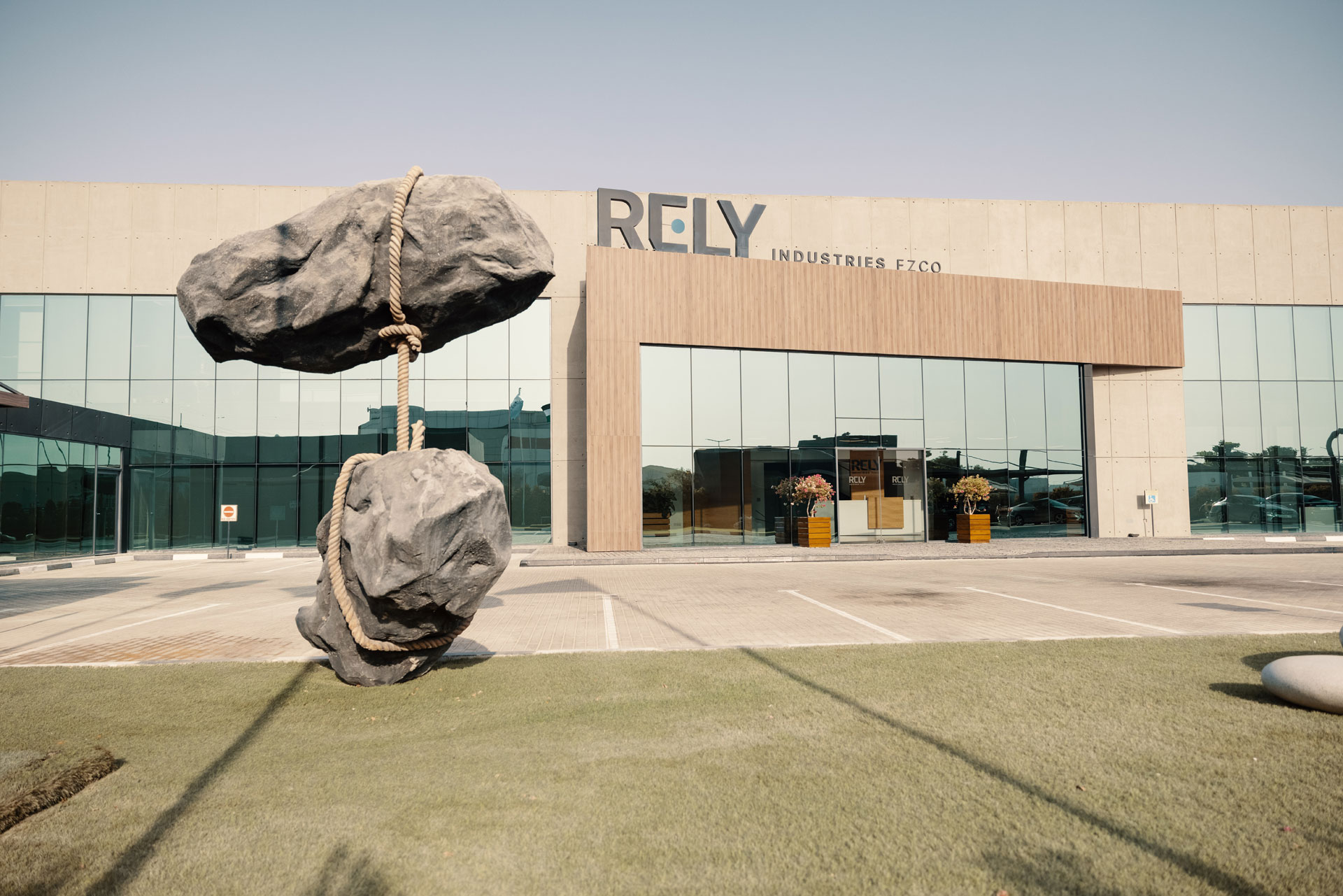 A rock sculpture in front of a building.